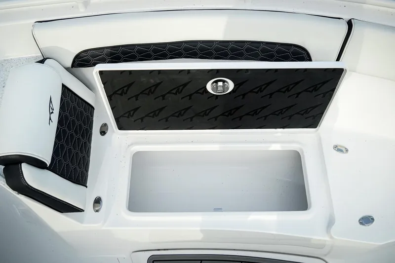 Slide: The Image of 2026 Tidewater 282 CC Adventure boat seat with storage compartment, featuring sleek black and white design. - 39