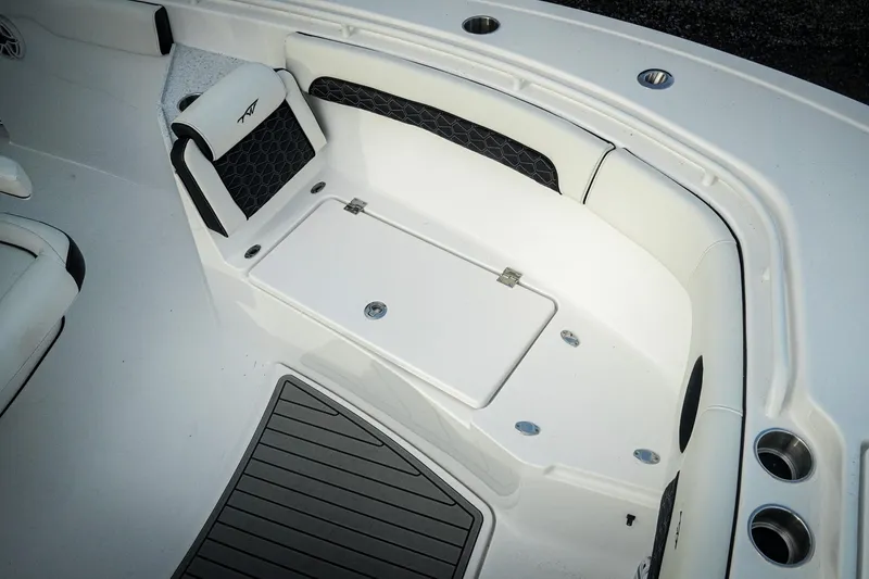 Slide: The Image of 2026 Tidewater 282 CC Adventure boat interior with cushioned seating and storage compartment. - 43