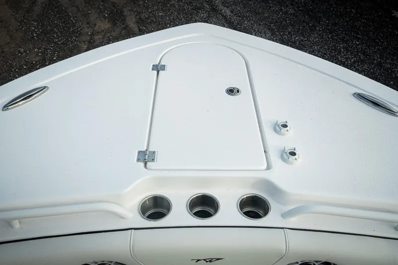 Slide: The Image of Bow of 2026 Tidewater 282 CC Adventure boat with storage hatch and cup holders. - 44