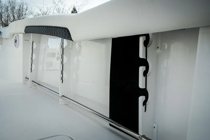 Slide: The Image of 2026 Tidewater 282 CC Adventure boat interior detail with rod holders and cushioned rail. - 46