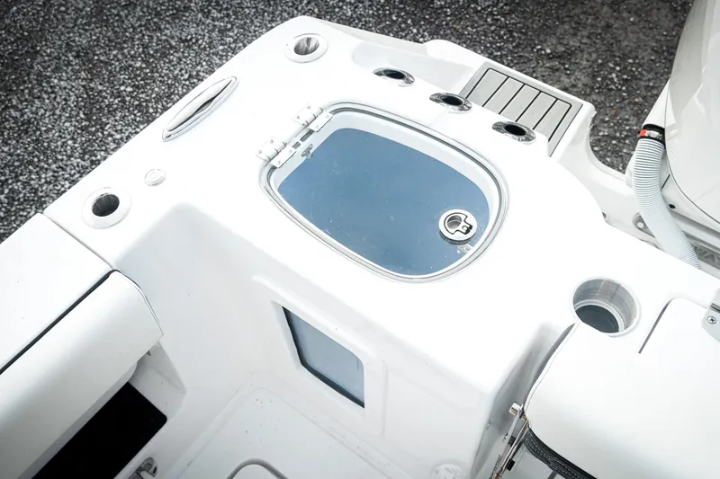 Slide: The Image of 2026 Tidewater 282 CC Adventure boat deck with storage compartments and cup holders. - 49