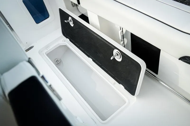 Slide: The Image of 2026 Tidewater 282 CC Adventure boat storage compartment with open lid. - 51