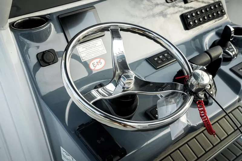 Slide: The Image of Steering wheel of 2026 Tidewater 282 CC Adventure boat, featuring modern controls. - 53