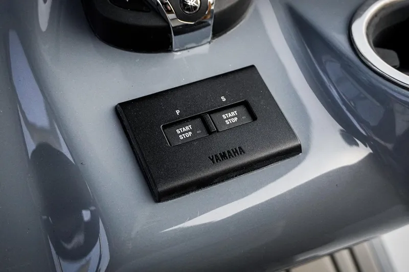 Slide: The Image of Yamaha start-stop buttons on 2026 Tidewater 282 CC Adventure boat dashboard. - 62