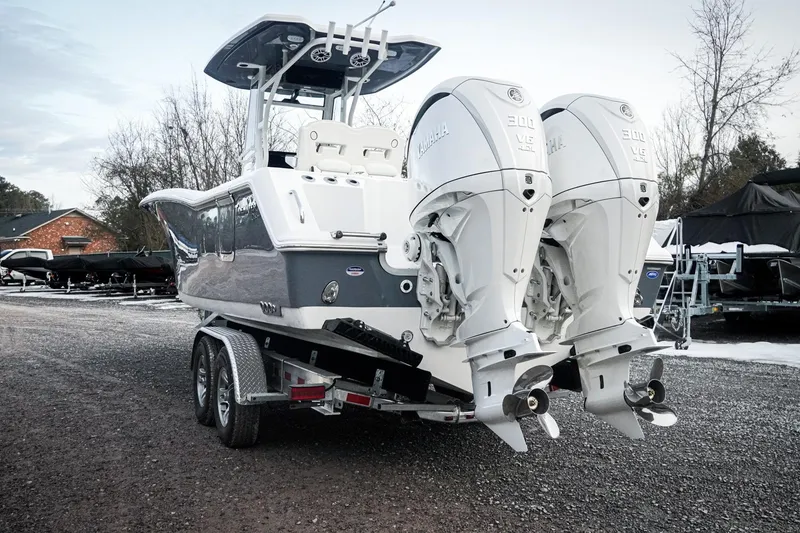 Slide: The Image of 2026 Tidewater 282 CC Adventure boat with dual Yamaha engines on a trailer. - 64
