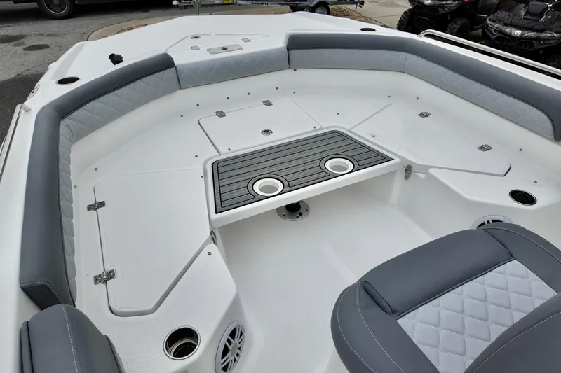 Slide: The Image of 2025 NauticStar 211 Hybrid boat interior with gray seating and storage compartments. - 13