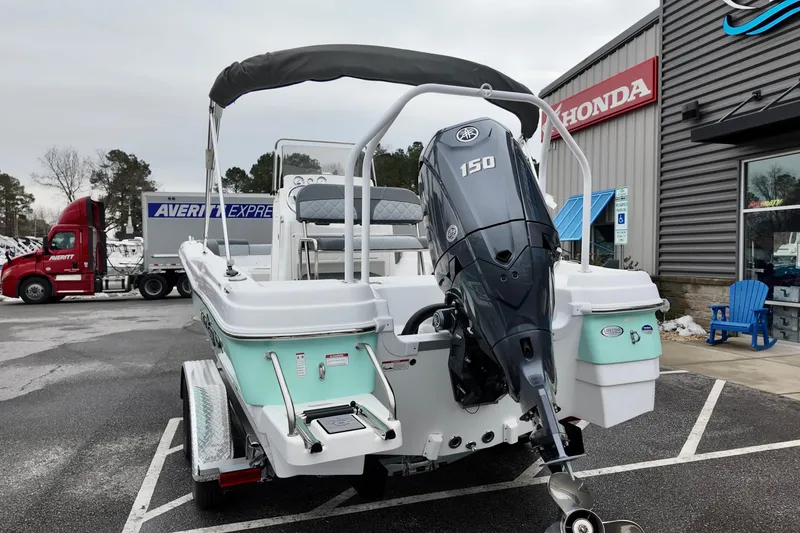 Slide: The Image of 2025 NauticStar 211 Hybrid boat with Yamaha 150 engine at dealership. - 14