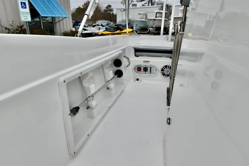 Slide: The Image of 2025 NauticStar 211 Hybrid boat interior with control panel and speaker. - 9