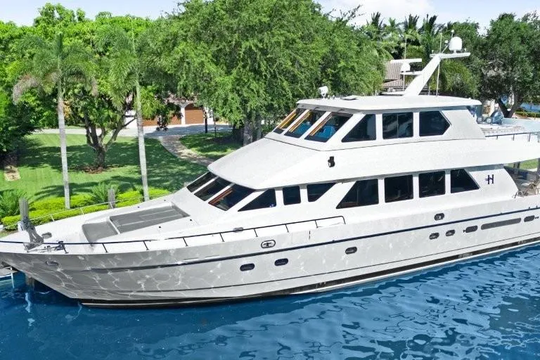 The Image of 2003 Hargrave Sky Lounge yacht docked by lush greenery and calm waters. - 0