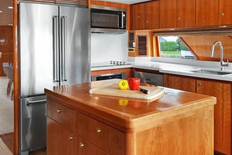 Slide: The Image of Luxurious 2003 Hargrave Sky Lounge yacht kitchen with wooden cabinetry and modern appliances. - 15