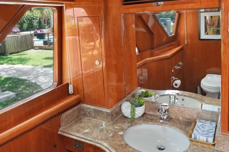 Slide: The Image of Luxurious bathroom interior of 2003 Hargrave Sky Lounge yacht with wooden finish and marble countertop. - 32