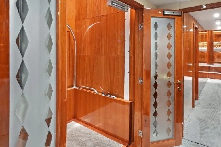 Slide: The Image of Luxurious interior of 2003 Hargrave Sky Lounge yacht with elegant wood paneling and glass doors. - 54