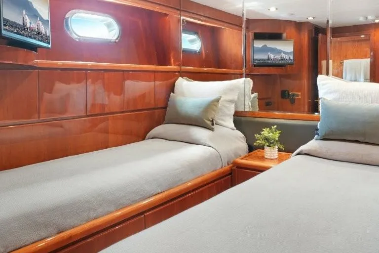 Slide: The Image of Luxurious 2003 Hargrave Sky Lounge yacht cabin with twin beds and elegant wood paneling. - 67