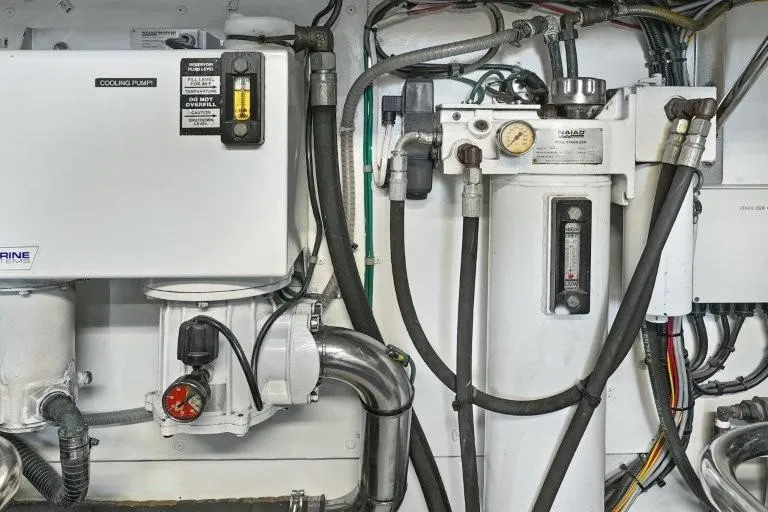 Slide: The Image of Engine room equipment of 2003 Hargrave Sky Lounge yacht, featuring cooling pumps and gauges. - 85