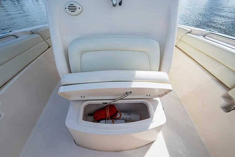 Slide: The Image of 2016 Grady-White Canyon 271 FS boat storage compartment with safety equipment. - 19
