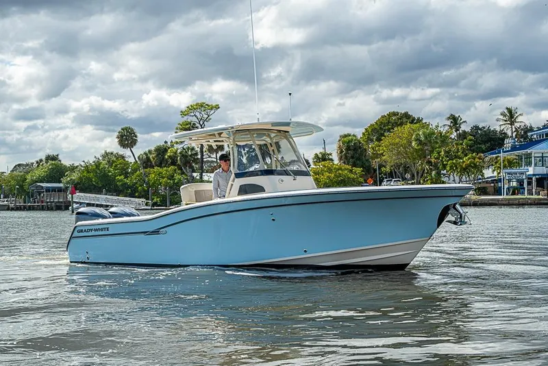 Slide: The Image of 2016 Grady-White Canyon 271 FS boat on calm water, under cloudy sky. - 3