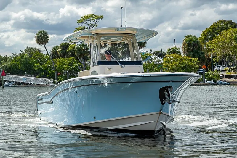 Slide: The Image of 2016 Grady-White Canyon 271 FS boat cruising on a scenic waterway. - 4
