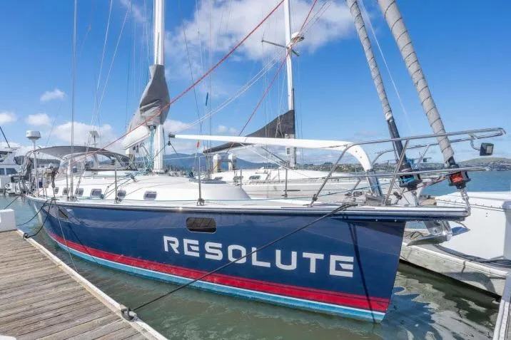 The Image of Sailboat "Resolute" docked, Blue Jacket 40 model, 2015, with clear skies and marina backdrop. - 1