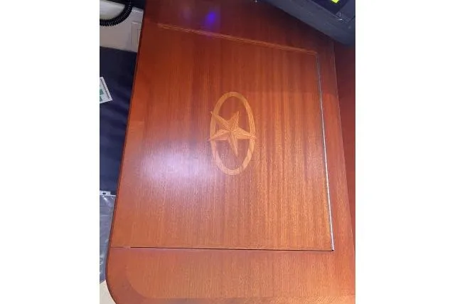 Slide: The Image of Wooden table with star emblem, part of a 2015 Blue Jacket 40 model interior. - 17