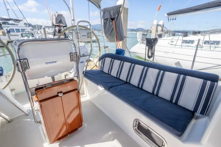 Slide: The Image of Cozy seating area on a 2015 Blue Jacket 40 sailboat, docked at a marina. - 24