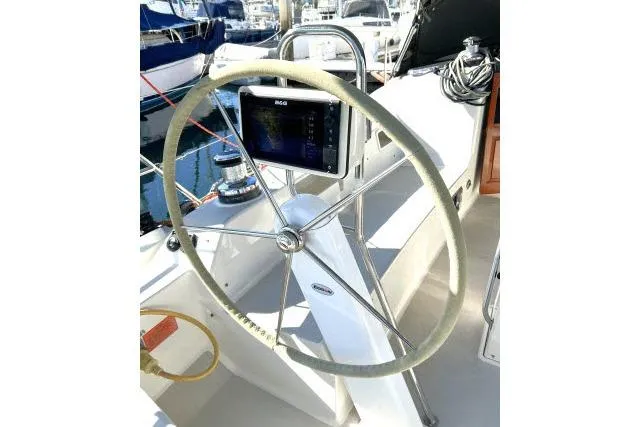 Slide: The Image of Steering wheel of 2015 Blue Jacket 40 sailboat, featuring navigation equipment. - 25