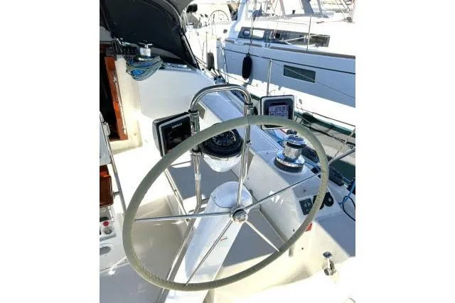 Slide: The Image of Steering wheel of a 2015 Blue Jacket 40 sailboat, docked in a marina. - 26