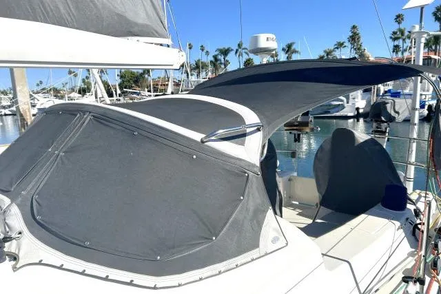 Slide: The Image of Sailboat with gray canopy docked in marina, Blue Jacket 40, 2015 model. - 34