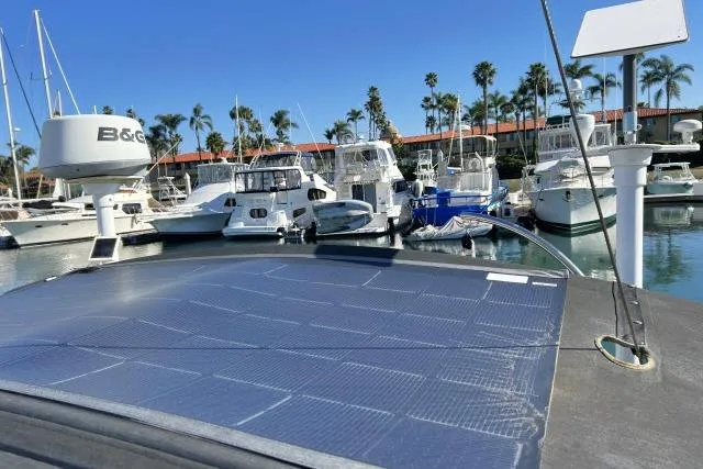 Slide: The Image of Solar panels on a 2015 Blue Jacket 40 yacht docked at a marina with palm trees. - 35