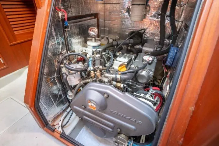 Slide: The Image of Engine compartment of a 2015 Blue Jacket 40 sailboat, featuring a Yanmar engine. - 46