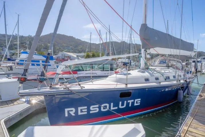 Slide: The Image of Sailboat "Resolute" docked, Blue Jacket 40 model, 2015, in a marina setting. - 50