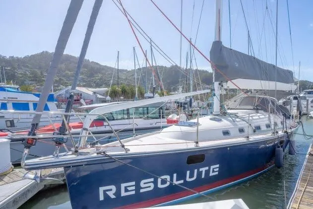 Slide: The Image of Sailboat "Resolute" docked, Blue Jacket 40 model, 2015, in a marina setting. - 51