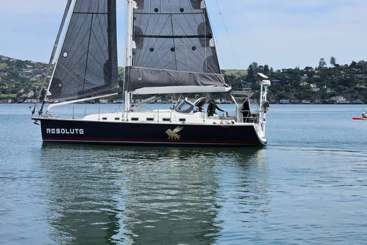 Slide: The Image of Sailboat "Resolute" on calm water, Blue Jacket 40 model, 2015, with scenic background. - 53