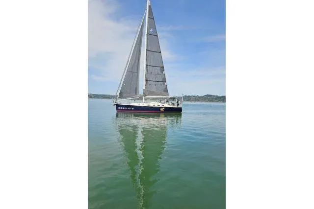 Slide: The Image of Sailboat "Blue Jacket 40" on calm water, 2015 model, clear sky background. - 55