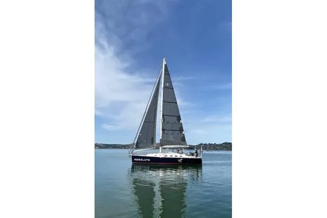Slide: The Image of Sailboat on calm water, Blue Jacket 40, 2015 model, under clear blue sky. - 56