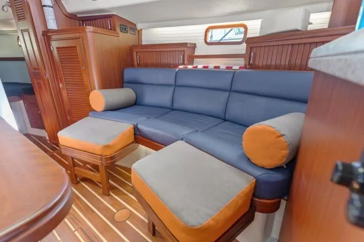 Slide: The Image of Luxurious Blue Jacket 40 yacht interior with blue and orange seating, wooden accents, 2015 model. - 7
