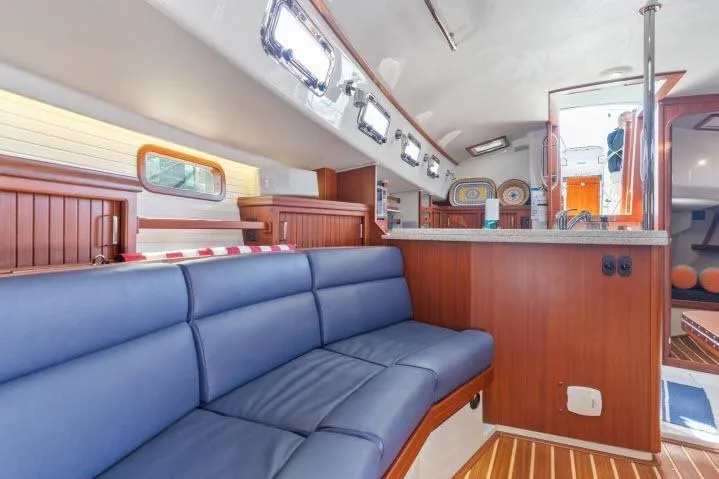 Slide: The Image of Luxurious interior of 2015 Blue Jacket 40 sailboat with blue seating and wooden accents. - 8