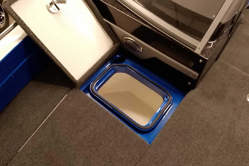 Slide: The Image of 2026 Ranger 620FS Cup-Equipped boat interior with open storage compartment. - 13