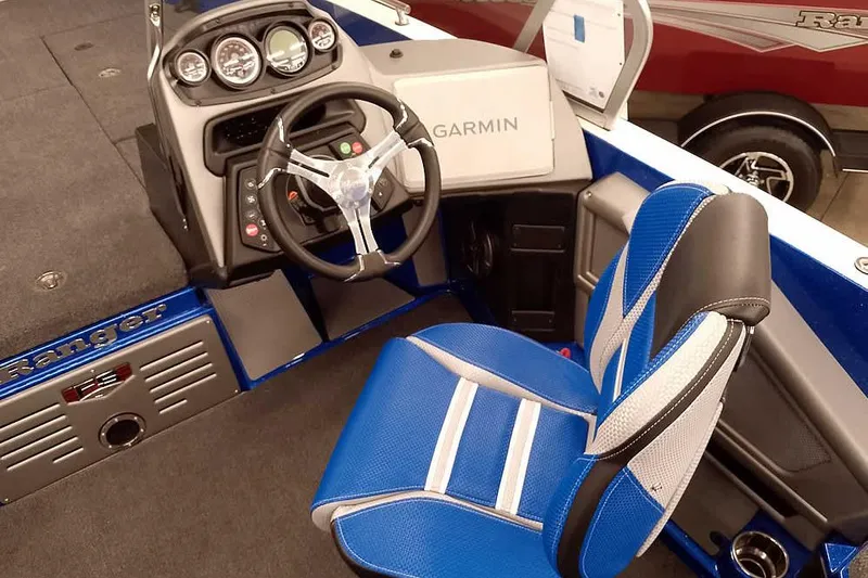 Slide: The Image of 2026 Ranger 620FS Cup-Equipped boat interior with Garmin navigation and blue seating. - 30