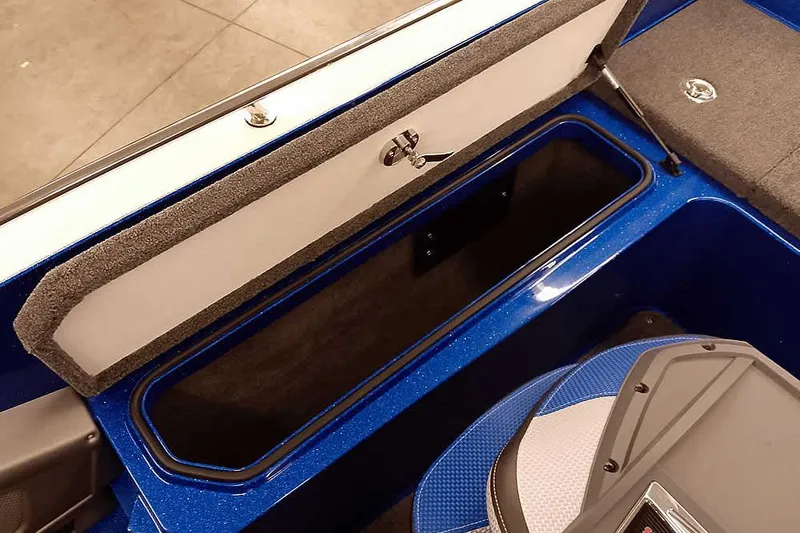 Slide: The Image of Open storage compartment in 2026 Ranger 620FS Cup-Equipped boat, featuring blue interior. - 36