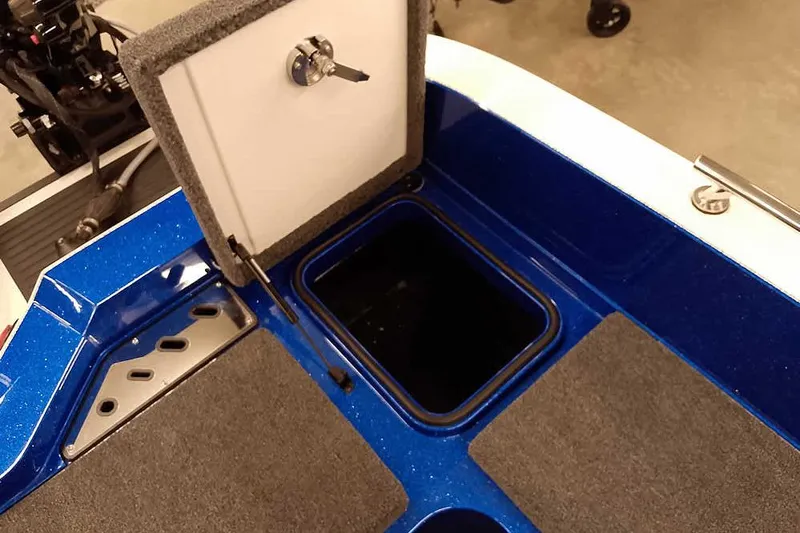 Slide: The Image of 2026 Ranger 620FS Cup-Equipped boat storage compartment with open hatch and carpeted surface. - 38