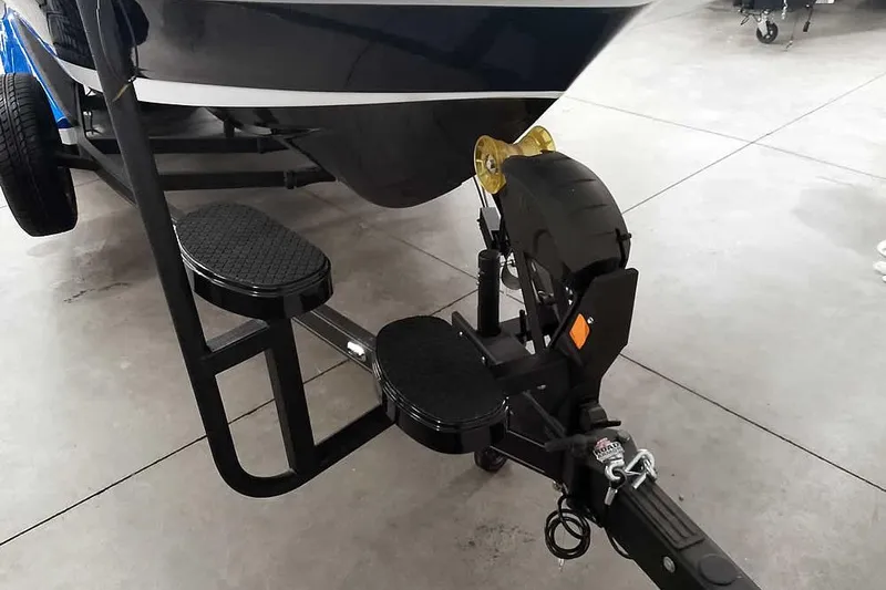 Slide: The Image of 2026 Ranger 620FS Cup-Equipped boat trailer with dual step design in a garage setting. - 4