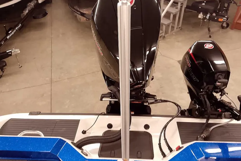 Slide: The Image of 2026 Ranger 620FS Cup-Equipped boat with dual outboard motors in showroom. - 43