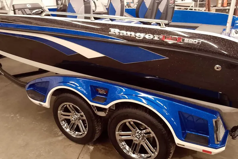 Slide: The Image of 2026 Ranger 620FS Cup-Equipped boat with blue and black design on a trailer. - 7