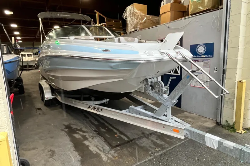The Image of 2023 Crownline Eclipse E235 XS boat on trailer in indoor storage. - 0