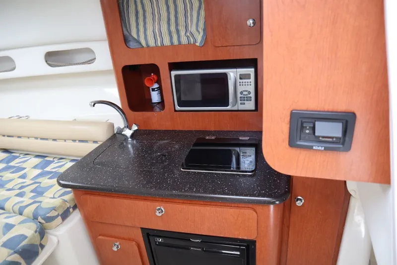 Slide: The Image of 2007 Pro-Line 32 Express boat interior kitchen area. - 19
