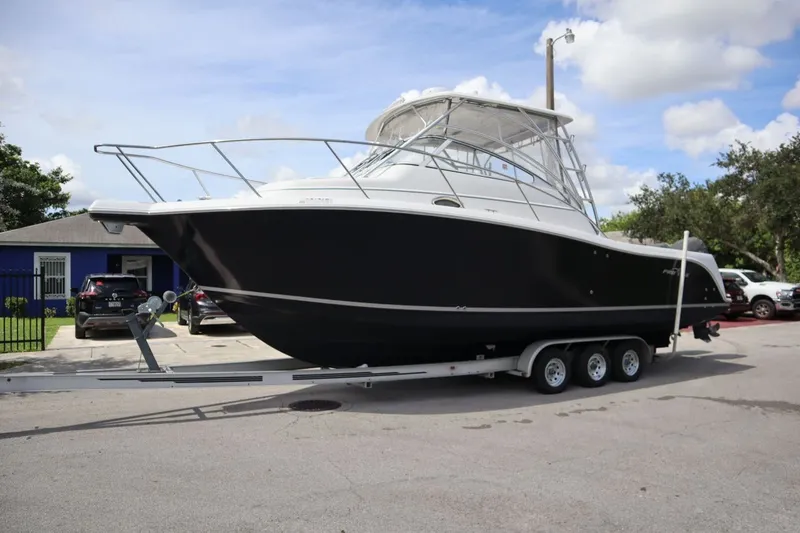 Slide: The Image of 2007 Pro-Line 32 Express boat on trailer, parked outdoors. - 2