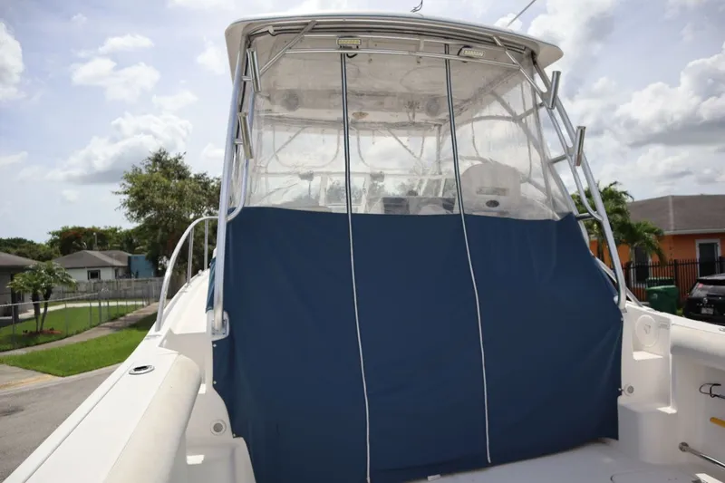Slide: The Image of 2007 Pro-Line 32 Express boat with blue cover outdoors. - 25
