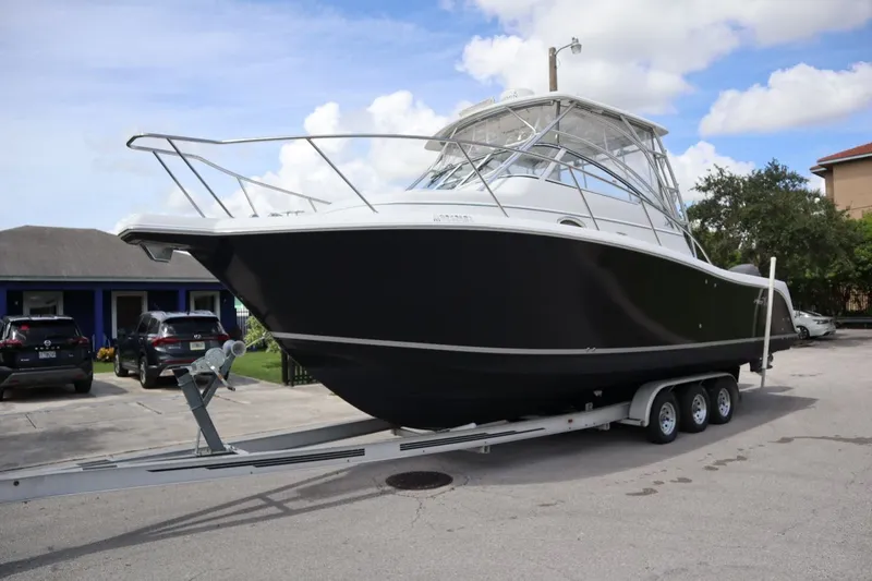 Slide: The Image of 2007 Pro-Line 32 Express boat on trailer, parked outdoors. - 3