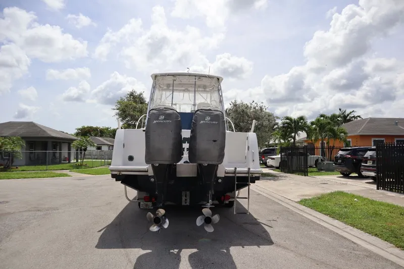 Slide: The Image of Rear view of a 2007 Pro-Line 32 Express boat on a street. - 6