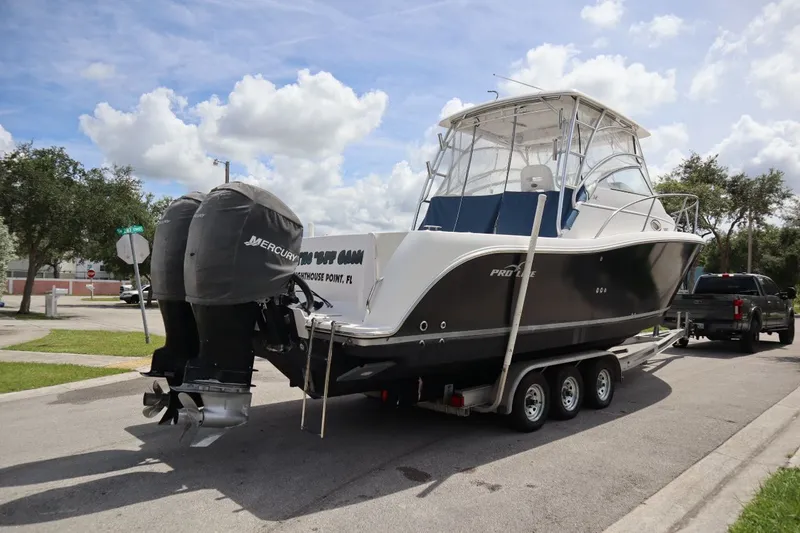 Slide: The Image of 2007 Pro-Line 32 Express boat on trailer with Mercury engines. - 7